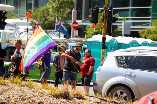 Guy holding LGBT flag - Convoy 2022 protest
