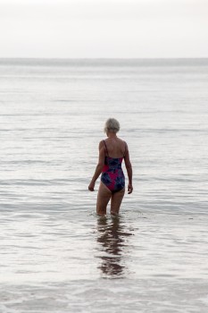 Woman walking into the water