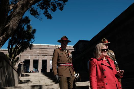 Uniformed soldiers walking down the stairs with a lady on Anzac Day 2017