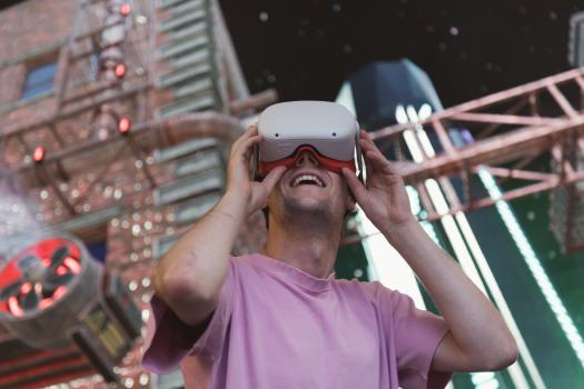 Guy in pink shirt using VR headset