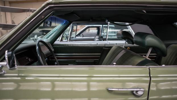 Side view of interior of a classic pillarless green car