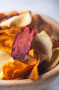 Close-up shot of chips in a wooden dish