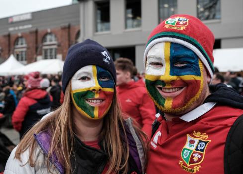 Couple face painted with British and Irish lions rugby team colours at a sporting event