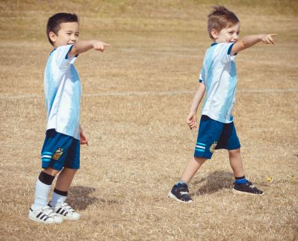 Two boys in Argentina team kit pointing fingers - Little Dribblers