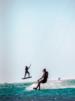 Kiteboarders Surf Wave Jumping Air