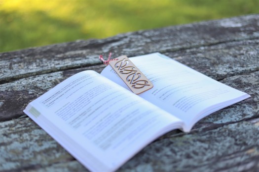 Maori tribal symboled bookmark on a book