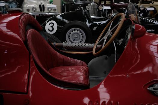 Classic red and black race cars at museum