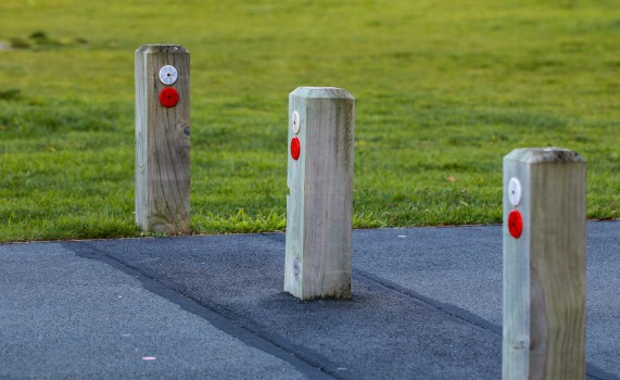 Three wooden posts in the ground