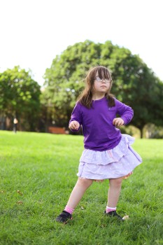 Cute girl in purple skirt with Down syndrome