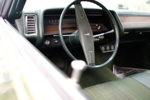 Interior of classic Pontiac steering wheel and speedometer