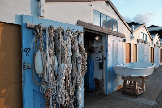 Ropes and marker buoys hanging on the door of a storage room