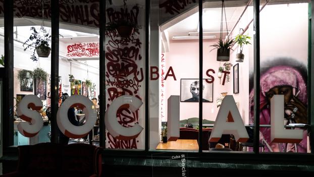 Grafitti filled walls as shopfront sign with artwork on cuba street barber shop