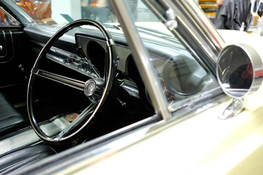 Classic white car black interior steering wheel and A-pillar window