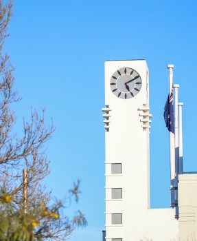 NZ flag next to town hall clock tower