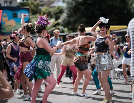 A group of women dancing in the street at Aro valley Fair 2021