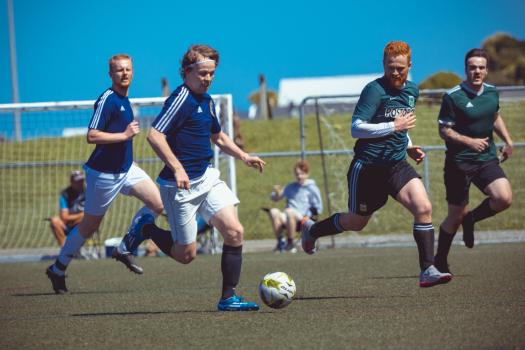 Fireraiders player dribbling football at Sports Zone sunday league