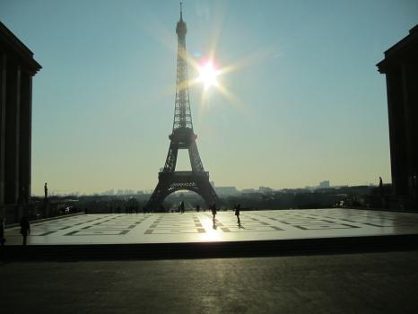 The Eiffel tower and silhouette of people on a sunny day