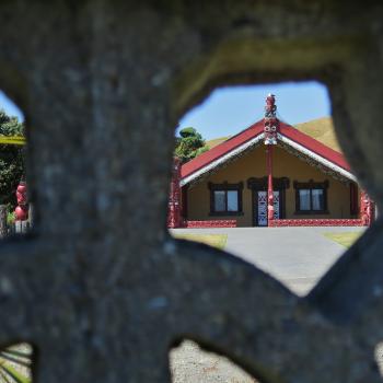 Maori architectured structure through a stone fence at Waitangirua