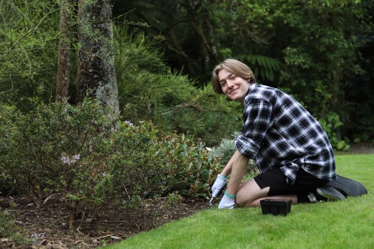 Guy in flannel shirt gardening