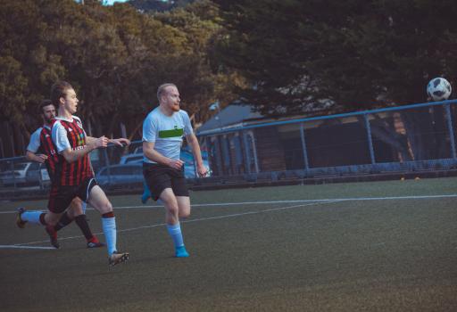 Player with red beard chasing after football - Sports Zone sunday league