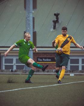 Player in green kit shooting football - Sports Zone sunday league