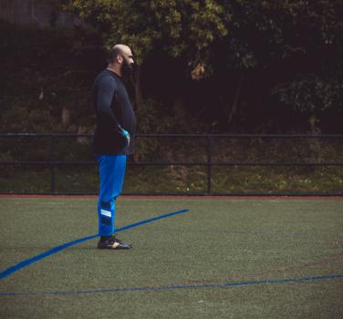 Goalkeeper in blue pants standing with hands on waist - Sports Zone sunday league
