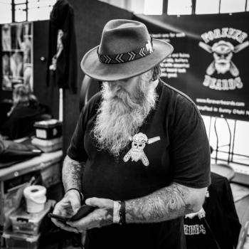 Old bearded guy wearing a hat at Wellington tattoo convention 2021 black and white