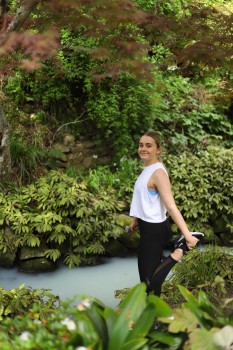 Woman exercising next to a stream