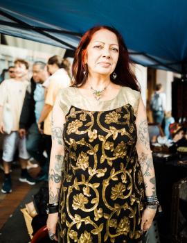 Woman with tattooed arms and spider necklace at Newtown festival 2021