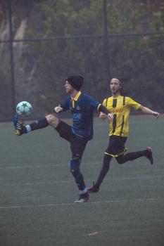 Player in beanie cap lifting ball with his foot - Sports Zone sunday league