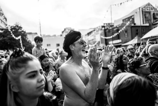 Bare-chested man clapping in crowd at Cuba Dupa 2021 B&W