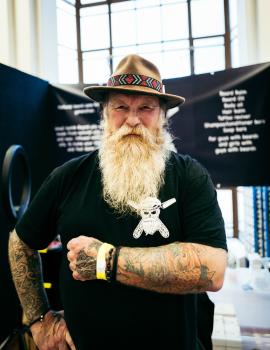 Old bearded guy wearing a brown hat at Wellington tattoo convention 2021