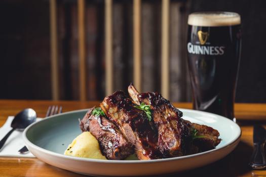 Finger licking delicious pork ribs and Guinness stout beer