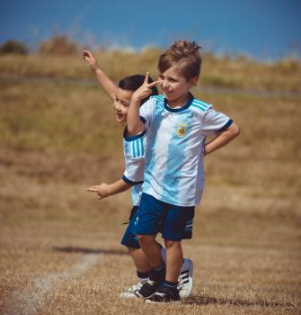 Boy in Argentina kit making victory sign - Little Dribblers