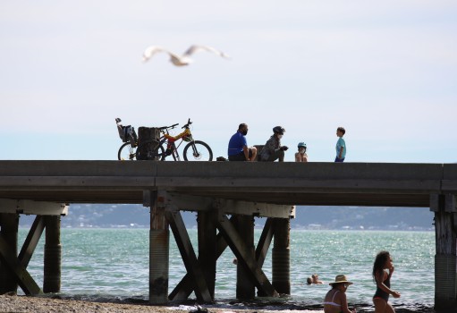 Cycling family resting on the pier