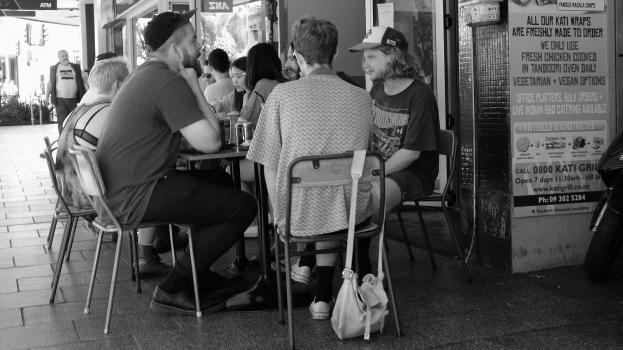 Customers sitting outside an Indian restaurant at K' road monochrome