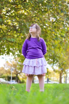 Little girl with Down syndrome posing outdoor