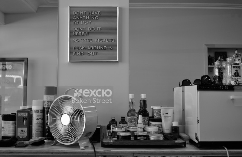 Hair essentials and a polite message in a barber shop black and white