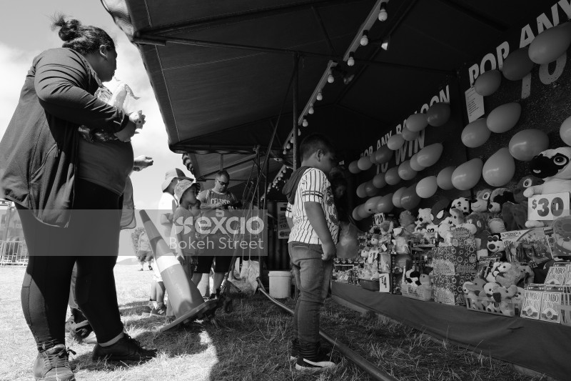 Child choosing his prize for winning a game monochrome
