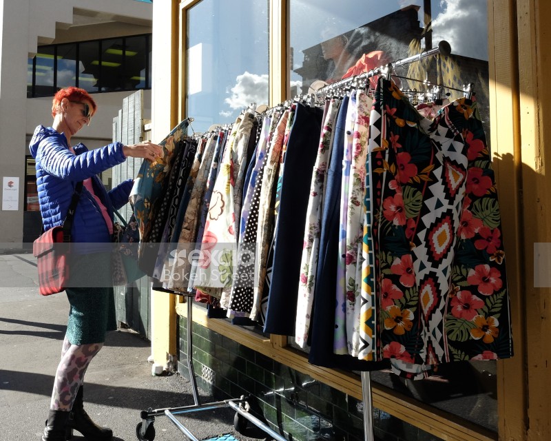 Woman browsing clothes outside a shop on Cuba Street