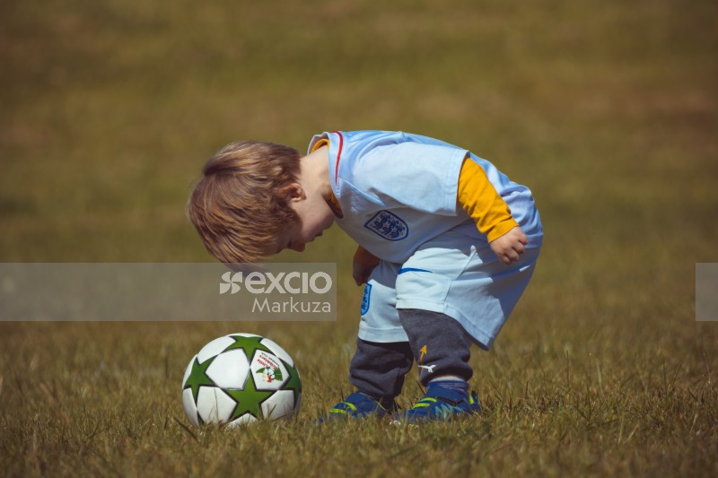 Boy in England kit bending down - Little Dribblers