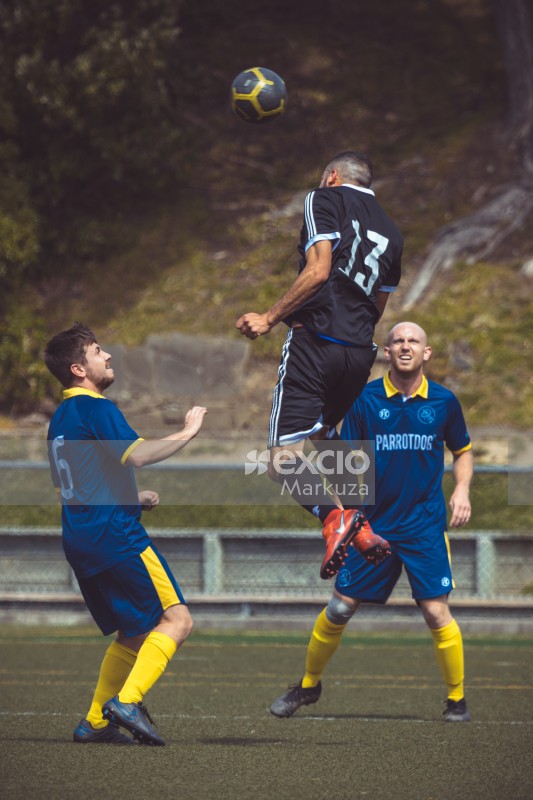 Player in black kit hitting football with head mid air - Sports Zone sunday league