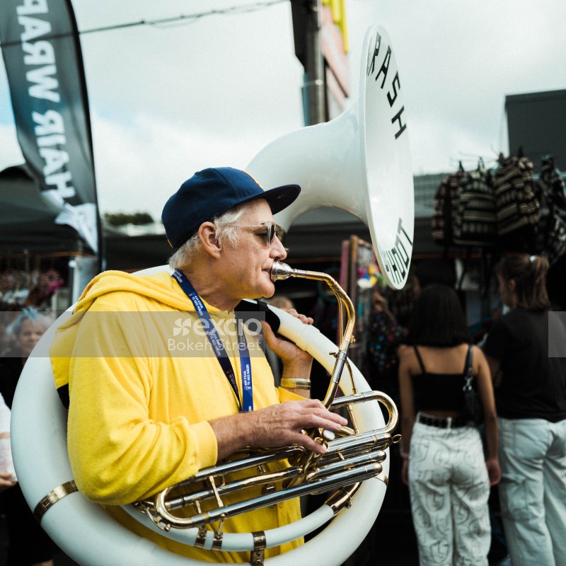 Old guy in yellow hoodie playing sousaphone at Newtown festival 2021