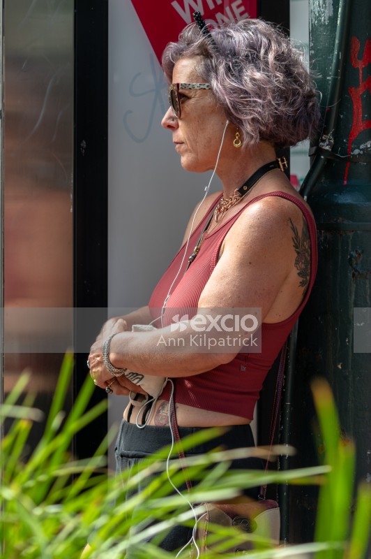 Woman watching street performers 