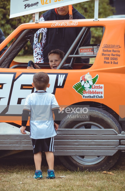 Kid inside orange race kart at Little Dribblers