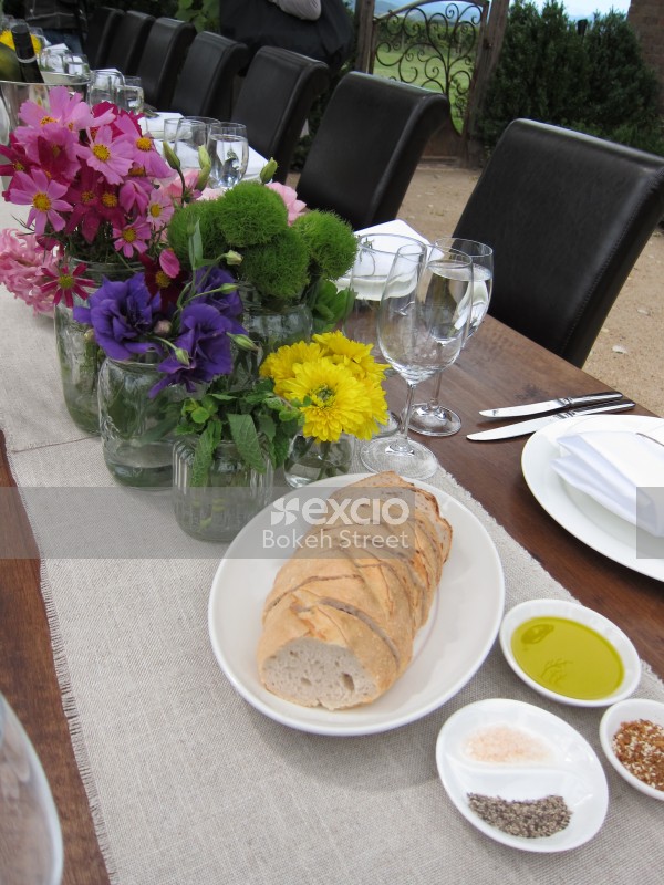 Bread and flowers on a dining table Set outdoors