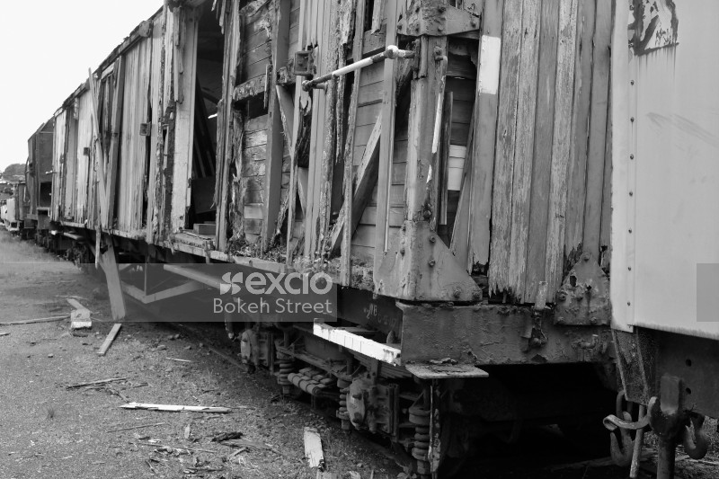 Damaged old wooden freight bogie monochrome