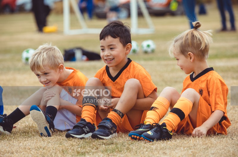Two boys and a girl in Netherland kit at Little Dribblers football game