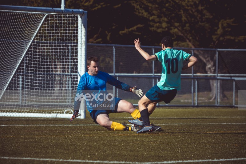 Goalkeeper trying to grab football before it scores a goal - Sports Zone sunday league