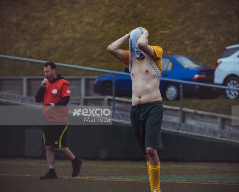 Player covering face with shirt bare belly - Sports Zone sunday league